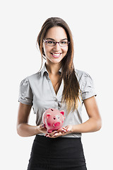 Image showing Woman holding a piggy bank