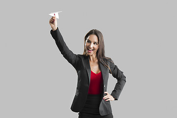 Image showing Woman throwing a paper plane