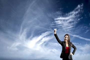 Image showing Business woman throwing a paper plane