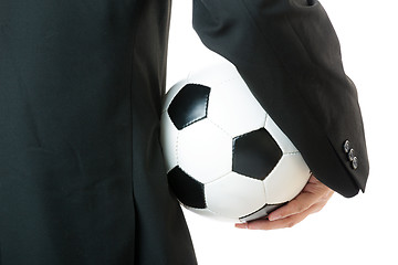 Image showing Back view of Businessman holding soccer ball 