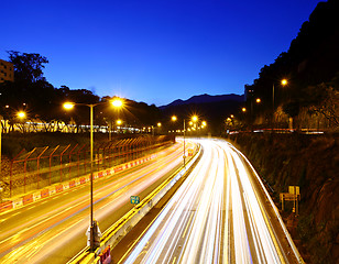 Image showing Traffic trail on highway during sunset