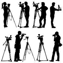 Image showing Cameraman with video camera. Silhouettes on white background. Ve