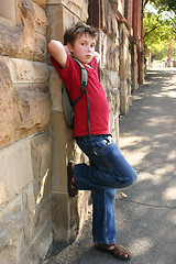 Image showing Child leaning against wall