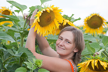 Image showing smiling woman with sunflower