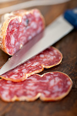 Image showing italian salame pressato pressed slicing