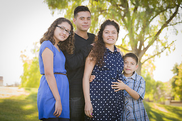 Image showing Happy Attractive Hispanic Family With Their Pregnant Mother Outd