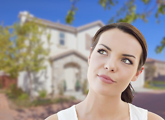 Image showing Thoughtful Mixed Race Woman In Front of House