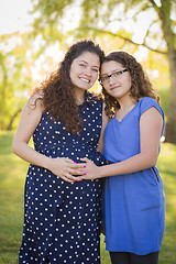 Image showing Hispanic Daughter Feels Baby Kick in Pregnant Mother’s Tummy 