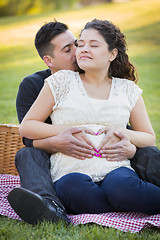 Image showing Pregnant Hispanic Couple Making Heart Shape with Hands on Belly