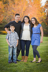 Image showing Attractive Hispanic Family Portrait in a Colorful Fall Outdoor S