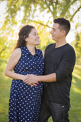 Image showing Hispanic Man With His Pregnant Wife Outdoors At the Park