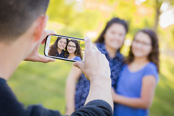 Image showing Man Takes Cell Phone Picture of Wife and Daughter