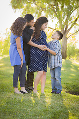 Image showing Happy Attractive Hispanic Family With Their Pregnant Mother Outd