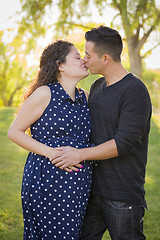 Image showing Hispanic Man Kisses His Pregnant Wife Outdoors At the Park