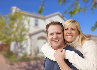 Image showing Happy Couple Hugging In Front of House