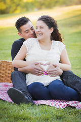 Image showing Pregnant Hispanic Couple Making Heart Shape with Hands on Belly