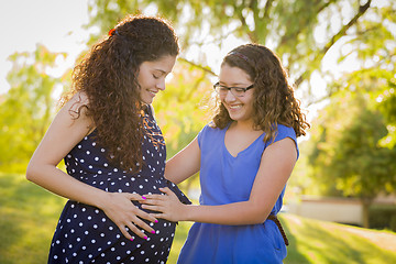 Image showing Hispanic Daughter Feels Baby Kick in Pregnant Mother’s Tummy 