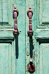 Image showing canarias brass  knocker in a green closed 