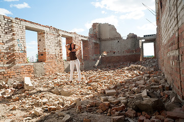 Image showing Grunge portrait of a woman in urban ruins