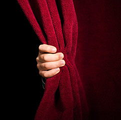 Image showing Hand appearing beneath the curtain.