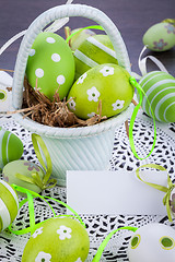 Image showing Colourful green Easter eggs in straw