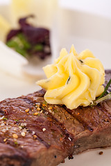 Image showing Grilled beef steak topped with butter and rosemary