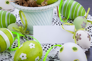 Image showing Colourful green Easter eggs in straw