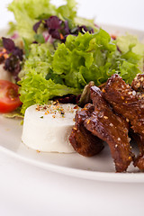 Image showing grilled beef stripes fresh salad and goat cheese