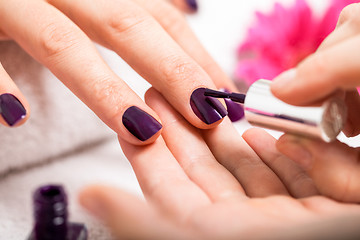 Image showing Woman having a nail manicure in a beauty salon