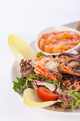 Image showing Grilled prawns with endive salad and jacket potato