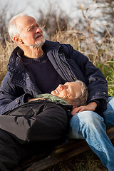 Image showing happy senior couple relaxing together in the sunshine