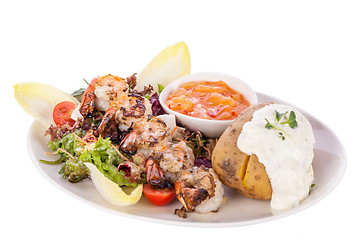 Image showing Grilled prawns with endive salad and jacket potato