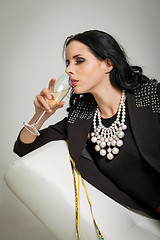 Image showing Seductive brunette holding a glass of champagne