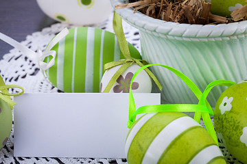 Image showing Colourful green Easter eggs in straw