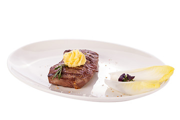 Image showing Grilled beef steak topped with butter and rosemary