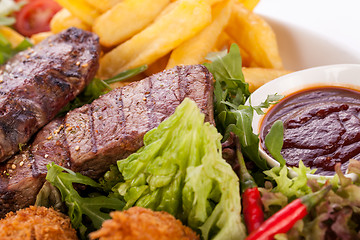 Image showing Platter of mixed meats, salad and French fries