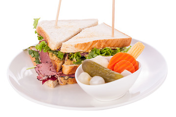 Image showing Delicious pastrami club sandwich and pickles