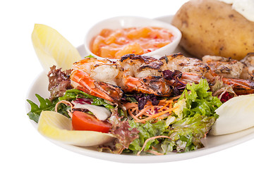 Image showing Grilled prawns with endive salad and jacket potato