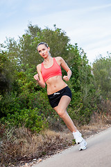 Image showing young athletic woman runner jogger outdoor