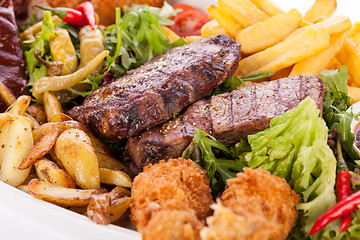 Image showing Platter of mixed meats, salad and French fries