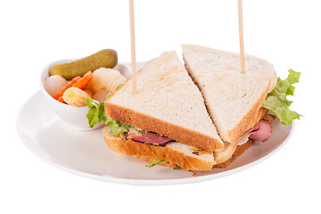 Image showing Delicious pastrami club sandwich and pickles