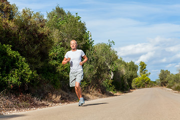 Image showing athletic man runner jogging in nature outdoor