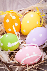 Image showing colorful easter egg decoration on wooden background