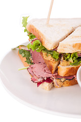 Image showing Delicious pastrami club sandwich and pickles