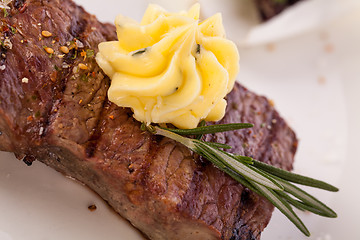 Image showing Grilled beef steak topped with butter and rosemary