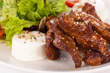 Image showing grilled beef stripes fresh salad and goat cheese