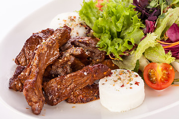 Image showing grilled beef stripes fresh salad and goat cheese