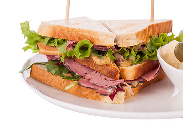 Image showing Delicious pastrami club sandwich and pickles