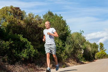 Image showing athletic man runner jogging in nature outdoor