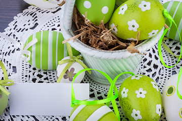 Image showing Colourful green Easter eggs in straw